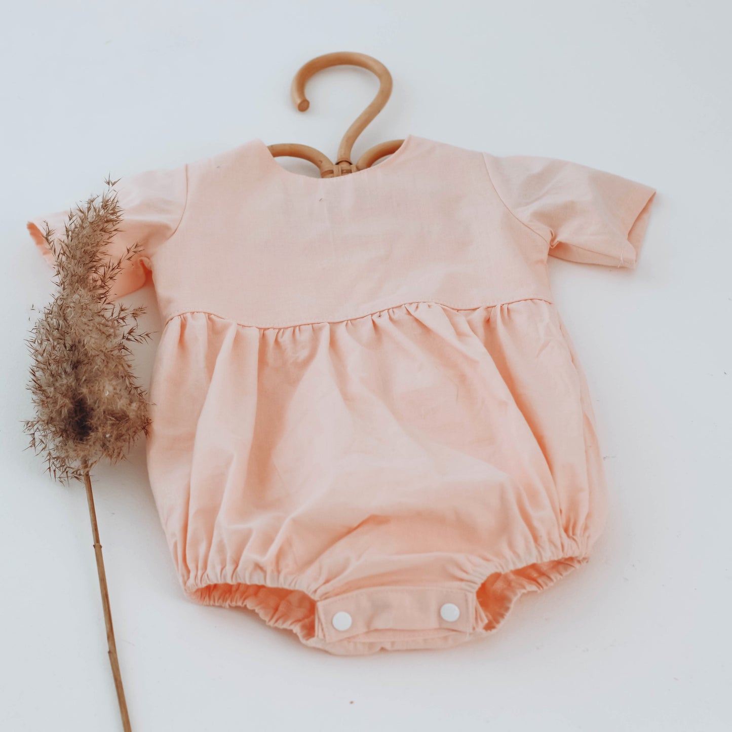 Peach romper with short sleeves